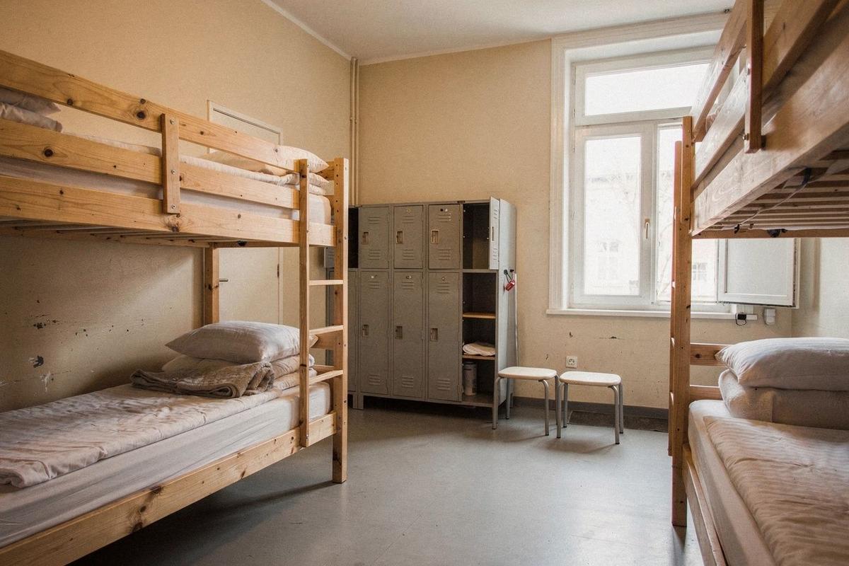 Dormitory room at Hostel Nordbahn in Berlin with wooden bunk beds and tall windows